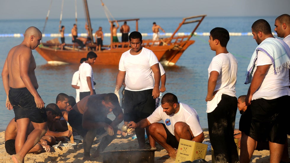 Kuwaiti pearl divers prepare for the upcoming of the Pearl Diving Festival in Kuwait City on August 13,2013. Pearl-diving trips are held annually in order to keep alive traditions that accompanied the once important national trade of pearl diving. (YASSER AL-ZAYYAT/AFP/Getty Images)