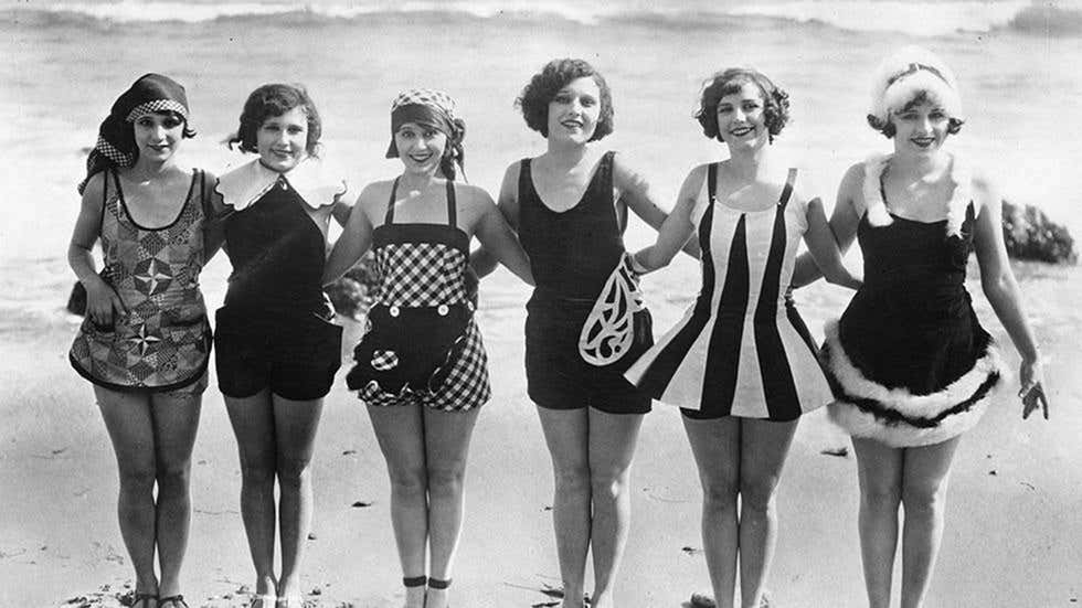A row women show off some unusual and original swimwear on the beach in 1929. A row women show off some unusual and original swimwear on the beach in 1929.