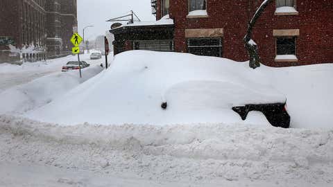 Feb. 9, 2015: Winter 2015 yielded the largest record snowfall in the city of Boston's history. Jillian Tenen's car went through weeks of storms and melting snow, staying frozen in place at the same on-street parking spot on Isabella Street. (Photo by David L. Ryan/The Boston Globe via Getty Images)