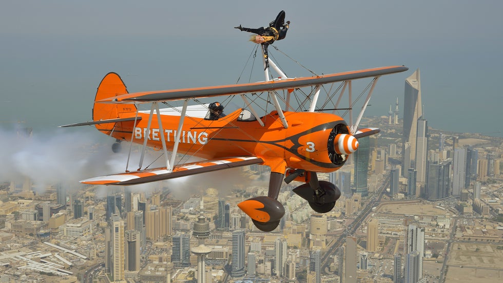 Breitling Wingwalker Freya Paterson flies above Kuwait City with pilots David Barrell and Martyn Carrington on Thursday, March  6, 2014.  The team loop and roll up to 160mph enduring G-forces of 4-5g. (Katsuhiko Tokunaga/Breitling via AP Images)