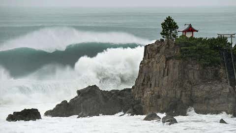 In this July 16, 2015 photo, waves crash against Katsurahama in Kochi on the island of Shikoku, western Japan, as a strong tropical storm sweeps across western Japan. (Kyodo News via AP)