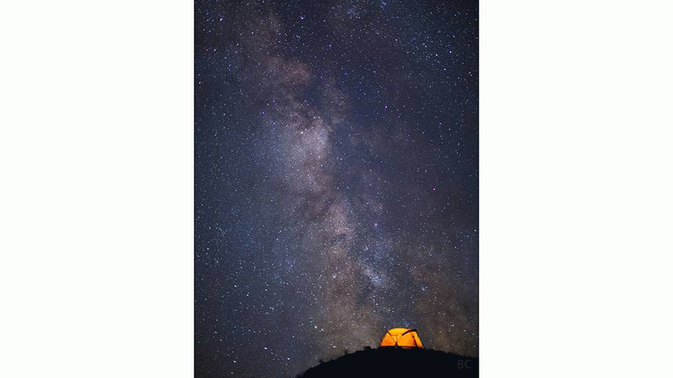 The Portland-based photographer captures the Milky Way in the Oregon night sky above a glowing tent in Deschutes, Ore. (Ben Canales)