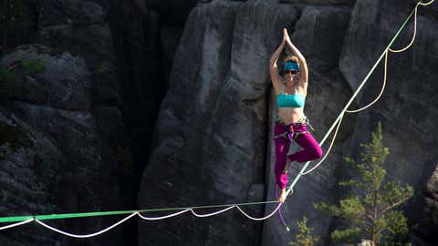 Daredevil Laetitia Gonnon pulls a yoga pose on a sackline in Ostrov, Czech Republic.