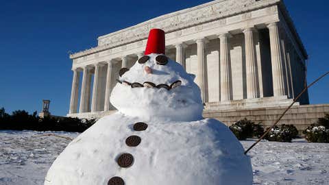 A snowman made with cookies and a red plastic cup sits in front of the Lincoln Memorial in Washington, Wednesday, Jan. 22, 2014. (AP Photo/Charles Dharapak)