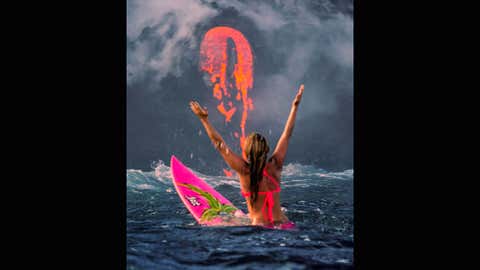 Alison Teal paddles out to Kilauea volcano in Hawaii as it erupts into the ocean.