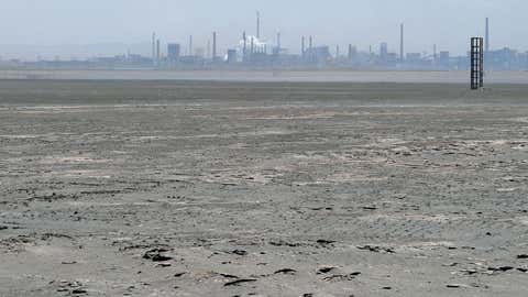 A vast expanse of toxic waste fills the tailings dam on April 21, 2011. Farmers living near the tailings dam, a 10-square-kilometer expanse of toxic waste, say they have lost teeth and their hair has turned white while tests show the soil and water contain high levels of cancer-causing radioactive materials. (FREDERIC J. BROWN/AFP/Getty Images)