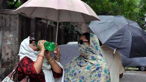 Women in India try to keep cool during a stifling heat wave in May 2015.