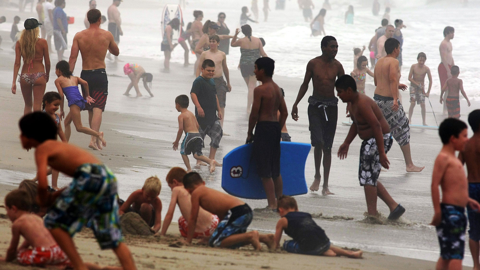 Beachgoers are shrouded in a marine layer over Zuma Beach on Thursday June 27, 2013, in in Malibu, Calif. (AP Photo/Los Angeles Times, Genaro Molina)