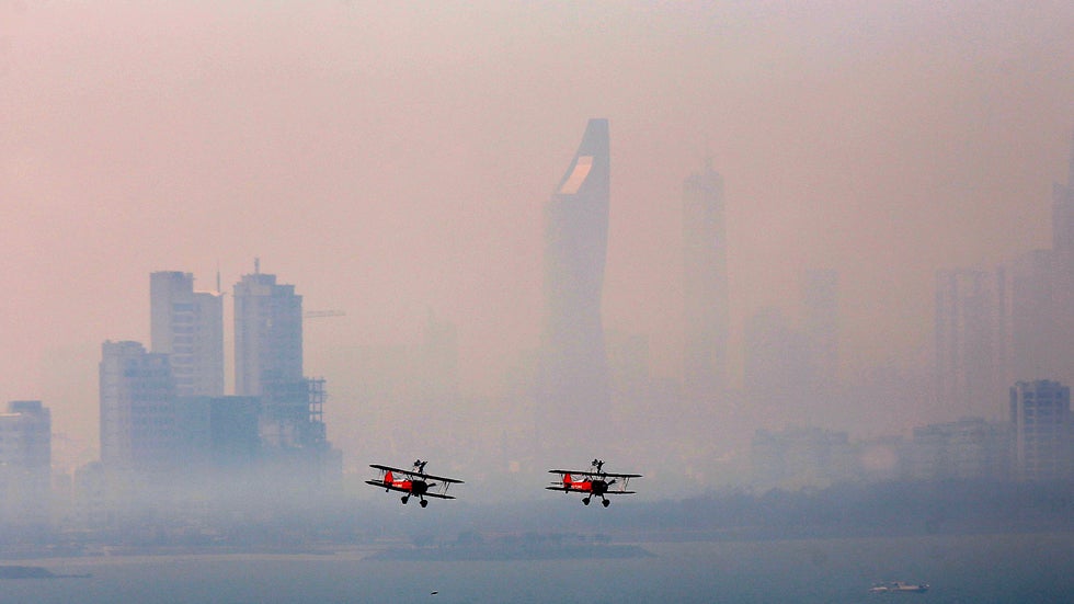 UK-based Breitling Wingwalkers display team performs over Kuwait City on March 8, 2014 during a promotional event to mark the opening of the first dedicated store of Breitling watches in Kuwait.  (YASSER AL-ZAYYAT/AFP/Getty Images)
