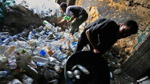 Egyptian workers collect plastic bottles at the poor area of al-Zabbalin on Oct. 20, 2008, in Cairo, Egypt. (Khaled Desouki/AFP/Getty Images)