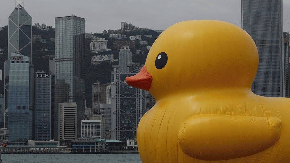 A giant Rubber Duck created by Dutch artist Florentijn Hofman is towed along Hong Kong's Victoria Habour, May 2, 2013. (AP Photo/Vincent Yu)