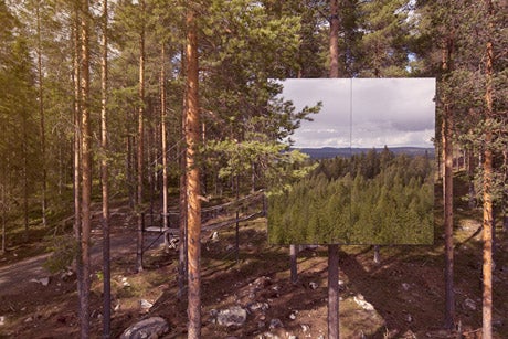 The Mirrorcube is camouflaged by mirrored walls that reflect their surroundings. The glass is actually treated with infrared that is visible to birds so they won't fly into it.(Photo: Treehotel)