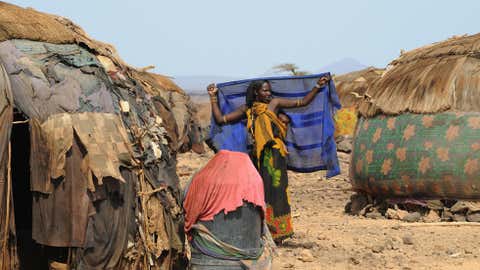 A Gabra woman stands outside her house in the village of Yaa-Sharbana on June 29, 2008 in North Horr, some 730 kms northeast of Nairobi. (SIMON MAINA/AFP/Getty Images)