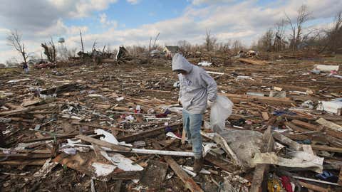 Tony Sherrard searches through debris that used to be his home for family keepsakes, March 3, 2012 in Marysville, Indiana. (Scott Olson/Getty Images)