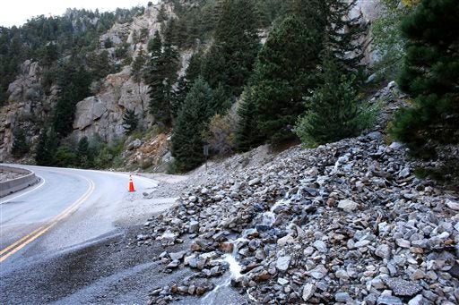 A rock slide partially blocks a closed canyon road, which links Boulder with the mountain town of Nederland, and which is damaged in places by recent flooding, up Boulder Canyon, west of Boulder, Colo., Friday Sept. 20, 2013. (AP Photo/Brennan Linsley)