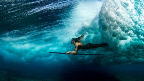 A surfer dives under a wave in Kailua Kona, Hawaii. (Sarah Lee)