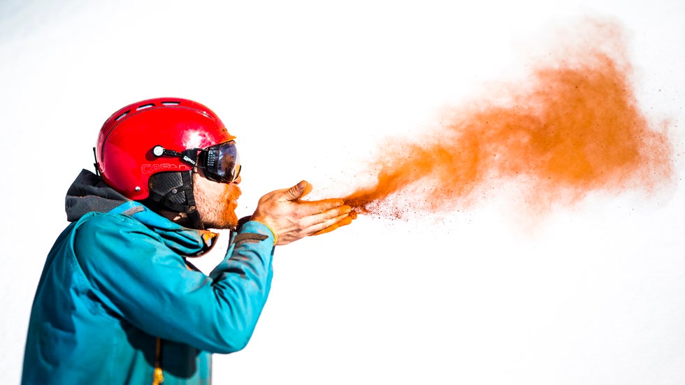 Mammut pro freerider Nicolas Falquet with the colored pigments he, his brother Loris and photographer Jeremy Bernard used to color the snow in Les Marecottes. (Jeremy Bernard and Mammut)