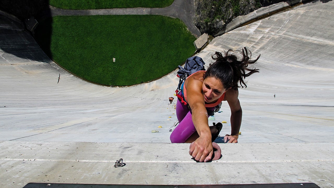 Fearless daredevils climb up Diga Di Luzzone, the world's highest man-made climbing wall. The wall runs up the face of a 540ft dam in Ticino, Switzerland. (Ilana Marcus/Caters News Agency)