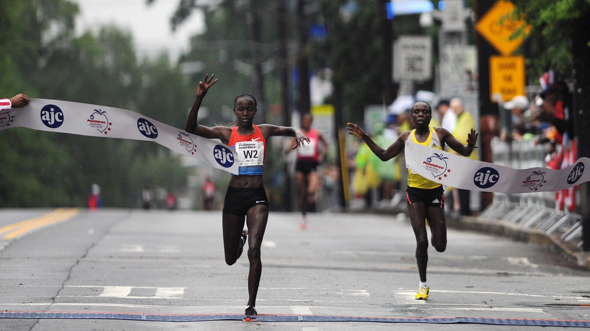 Lineth Chepkurui, of Kenya, breaks the tape to win the women's division of the AJC Peachtree Road Race, Thursday, July 4, 2013, at Piedmont Park, in Atlanta. (AP Photo/Atlanta Journal-Constitution, Johnny Crawford)
