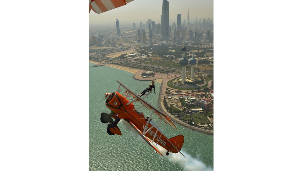 Breitling Wingwalker Freya Paterson flies above Kuwait City with pilots David Barrell and Martyn Carrington on Thursday, March  6, 2014.  The team loop and roll up to 160mph enduring G-forces of 4-5g. (Katsuhiko Tokunaga/Breitling via AP Images)
