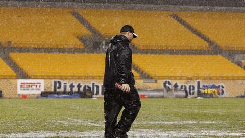 Workers try and prepare the field during a lightling delay prior to a game between the Miami Dolphins and Pittsburgh Steelers on Nov. 26, 2007, at Heinz Field in Pittsburgh. (Gregory Shamus/Getty Images)