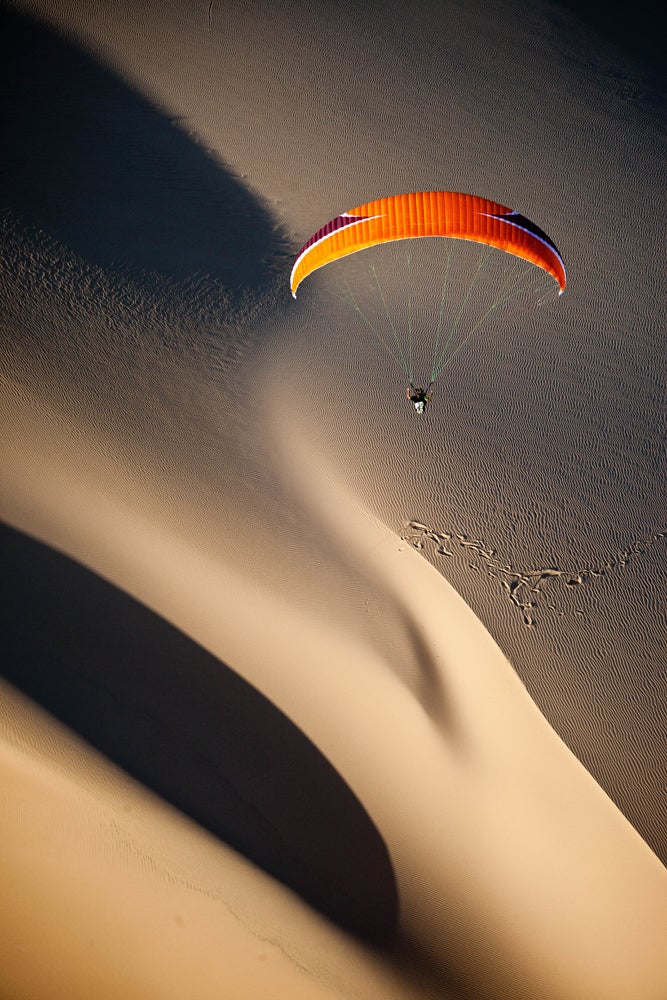 MacDonald says the winds around the sand dune were ideal for paragliding. (Image: Jody MacDonald)