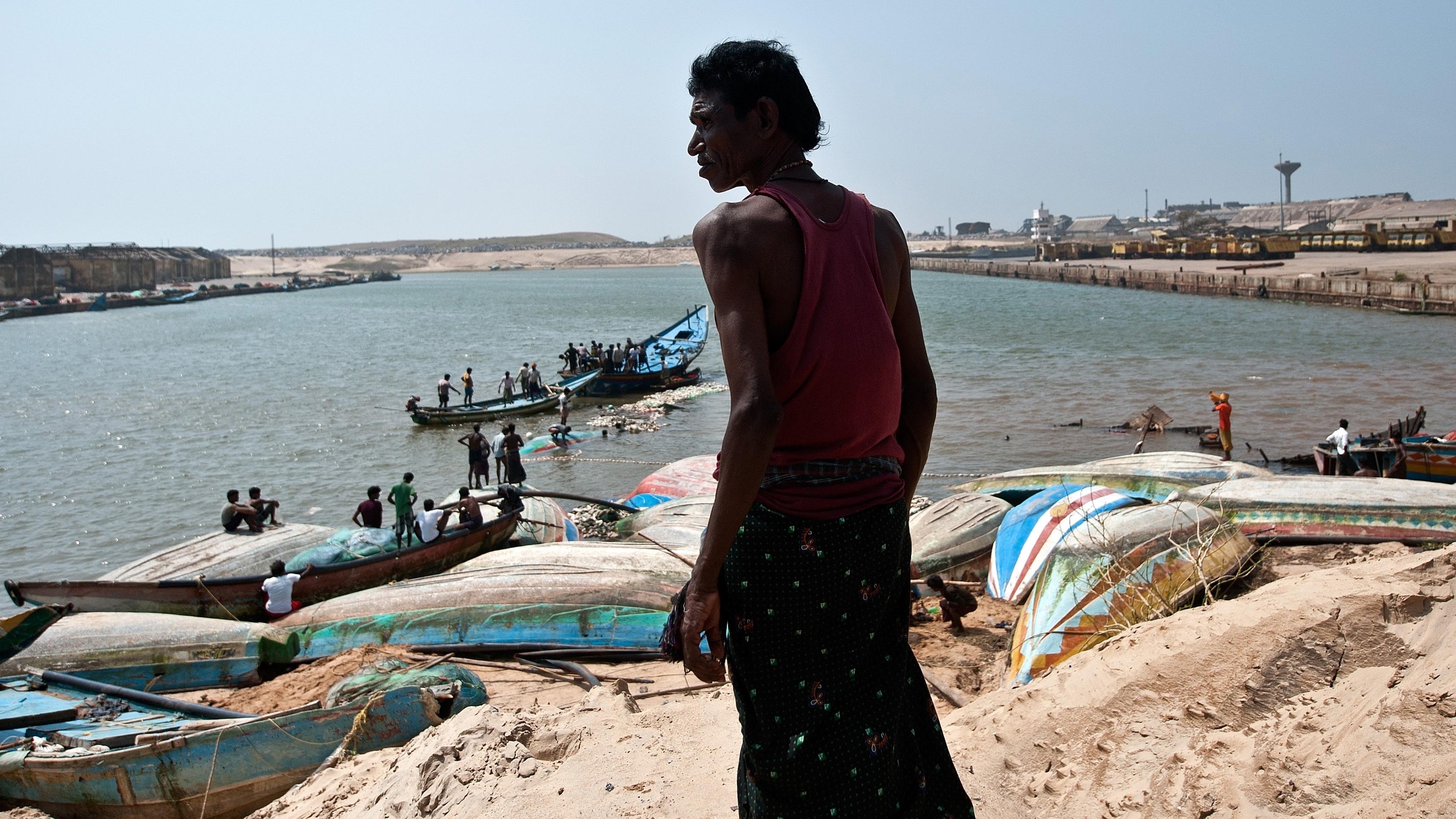 An Indian fisherman looks at boats destroyed by Cyclone Phailin at the Gopalpur Port on October 14, 2013. (MANAN VATSYAYANA/AFP/Getty Images)