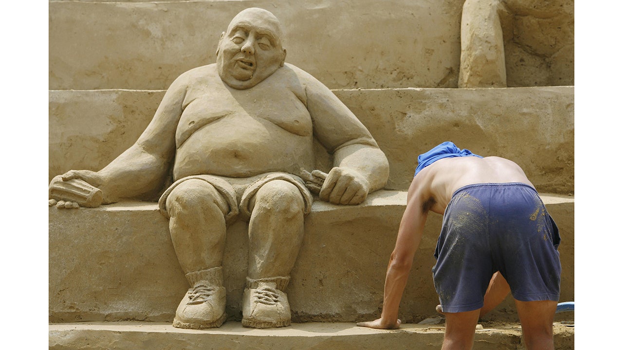 Berlin-Schonefeld Apt, GERMANY:  An artist works on his sculpture during the fourth international sand sculpture festival "Sandsation" in Berlin 16 June 2006. About 35 artists from around the world took part in the competition. Gianni Schiumarini of Italy was awarded the Artist's Trophy for her sand sculpture "Fighting the Ball". The festival ends 16 July 2006. AFP PHOTO   DDP/JOHANNES EISELE      GERMANY OUT  (Photo by JOHANNES EISELE/AFP/Getty Images)