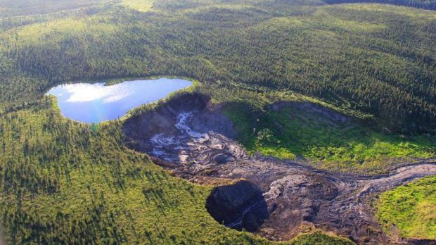 This small lake, which overlooks a permafrost thaw slump near Fort McPherson in Canada's Northwest Territories, is poised to fall over the cliff below when the thawing permafrost holding it up finally collapses. (Scott Zolkos, University of Alberta/Northwest Territories Geological Survey)