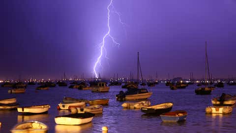 Lightning strikes over Poole Harbour during a thunderstorm on July 21, 2013, in Poole, England. (Dan Kitwood/Getty Images)