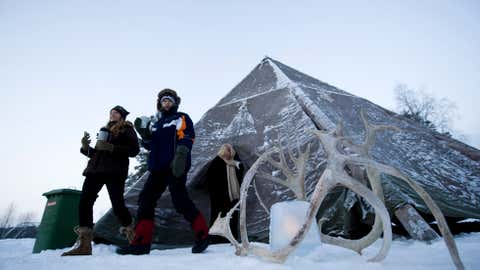 People step out of a Lapp tent on December 20, 2010 near the village of Vuollerim, Lapland province, west of the costal city of Luleaa, Sweden. (JONATHAN NACKSTRAND/AFP/Getty Images)