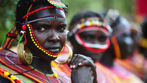 Pokot tribeswomen look on at the Gallmann nature conservancy near Kinamba, Laikipia, Northern Kenya on March 4, 2012. High Priest Shinso Ito and a group of Shinnyo-en priests arrived in Kenya to perform a Buddhist fire and water ceremony for the first time ever in Africa. (CARL DE SOUZA/AFP/Getty Images)