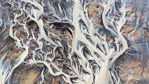 These abstract photos may look like paintings or a view through a microscope, but they are aerial photos of Icelandic river formations. (Emmanuel Coupe-Kalomiris)