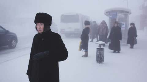 A Yakutian woman in the city centre. Steam from factories, cars and people creates a thick fog in winter which lingers through the coldest weeks. (Amos Chapple)