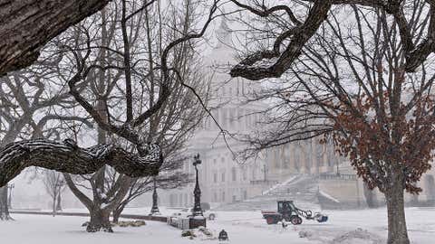 A snowplow clears snow on Capitol Hill in Washington, Monday, March 3, 2014. The National Weather Service has issued a Winter Storm Warning for the greater Washington Metropolitan region, prompting area schools and the federal government to close for the wintry weather.  (J. Scott Applewhite/AP Photo)