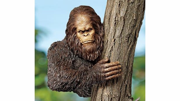 Bigfoot tries to hide behind a tree branch in this sculpture. (Image: Skymall.com)