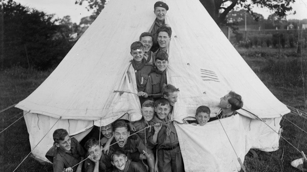 August 1926: Boy Scouts crammed into a tent during a camping holiday at Muswell Hill in London. (Fox Photos/Getty Images)