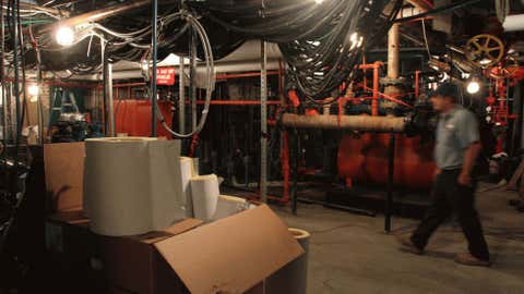 Chief engineer Mike Lahm walks through the pump room as he shows journalists the basement of 120 Wall Street in New York. The basement was totally submerged during Superstorm Sandy. (AP Photo/Tina Fineberg)