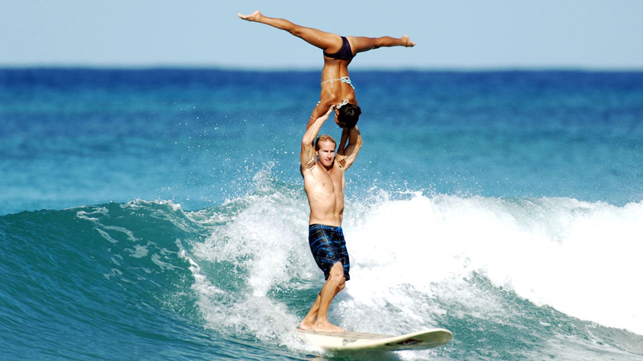 Chuck Inman and Lauren Oiye take part in some tandem surfing in Waikiki. (Mark Klintworth/Caters News)