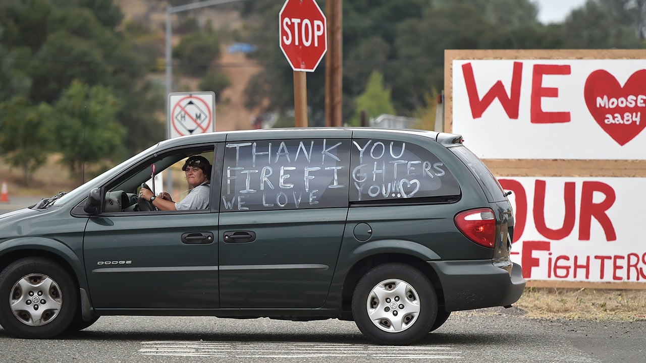 Diane Beavers drives away from the Moose Lodge in Clearlake Oaks, Calif., after donating food to evacuees on Tuesday, Aug. 4, 2015. The Rocky fire continues to burn and has charred more than 65,000 acres and destroyed 24 residences. (AP Photo/Josh Edelson)
