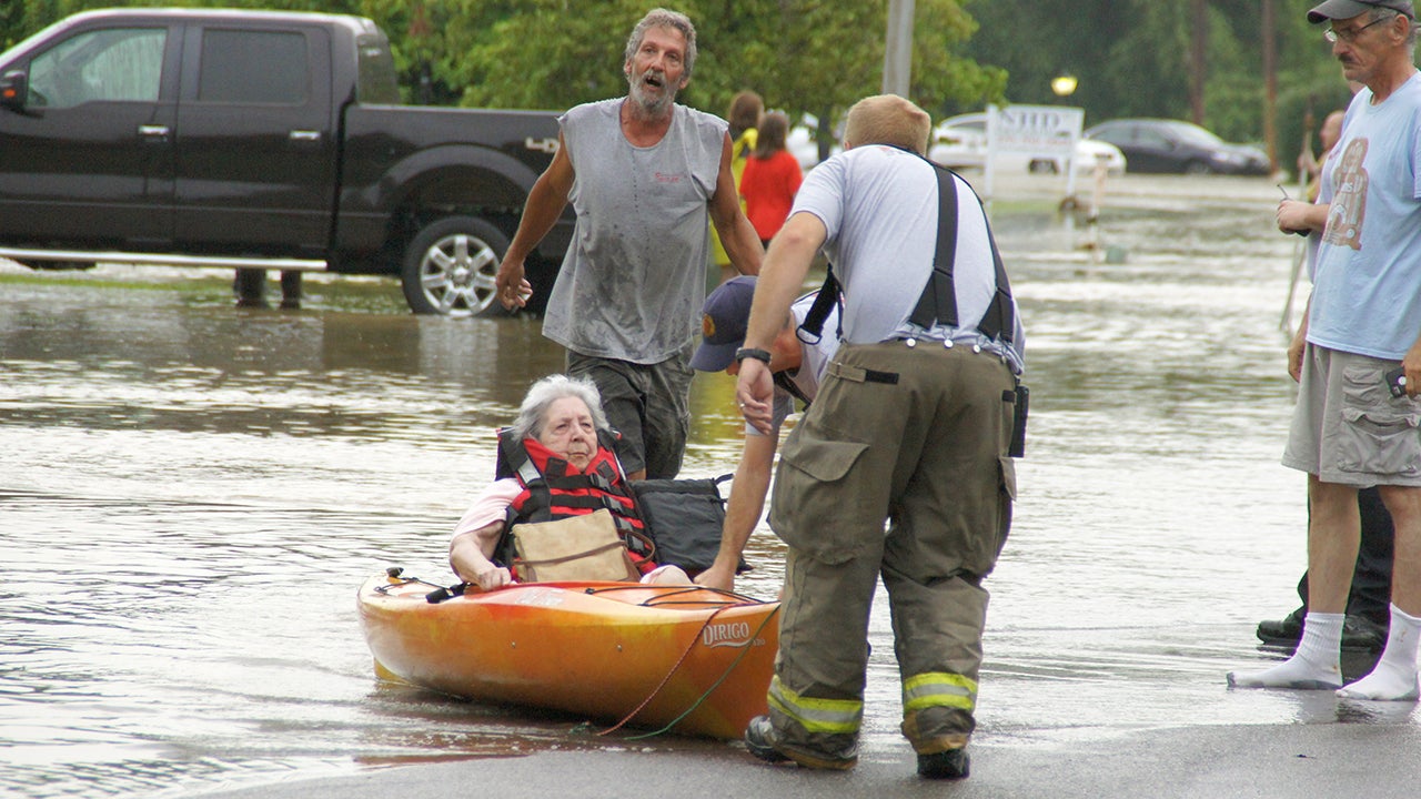 An elderly woman is rescued by boat from her apartment, in Paducah, Ky., Tuesday, July 7, 2015. Heavy rain in part of western Kentucky has led to multiple water rescues including at an apartment complex that was evacuated. The National Weather Service said radar showed that 3 to 5 inches of rain fell Tuesday morning in areas of McCracken, Ballard, Marshall and Livingston counties. (Gary Goin West Kentucky Star (WKYX)/AP)