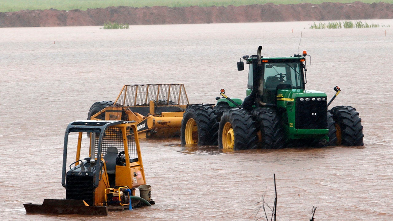 Construction equipment sits in high water from overnight rains off Interstate 35 on Thursday, June 18, 2015, in Pauls Valley, Oklahoma. (Steve Sisney/The Oklahoman via AP) 