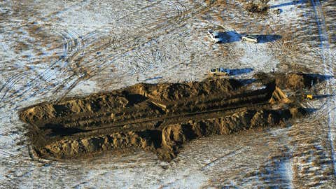 Crews work to contain an oil spill from Bridger Pipeline's broken pipeline near Glendive, Mont. in this aerial view on Monday, Jan. 19, 2015. (AP Photo/The Billings Gazette, Larry Mayer)