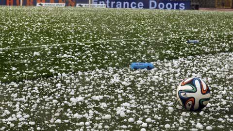 The ball lays among hailstones on the field, during the friendly football match between Belgium and Tunisia, at the King Baudouin stadium, in Brussels. (THIERRY ROGE/AFP/Getty Images)