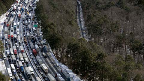 This aerial photo, traffic is snarled along the I-285 perimeter north of the metro area after a winter snow storm Wednesday, Jan. 29, 2014, in Atlanta. (AP Photo/David Tulis)