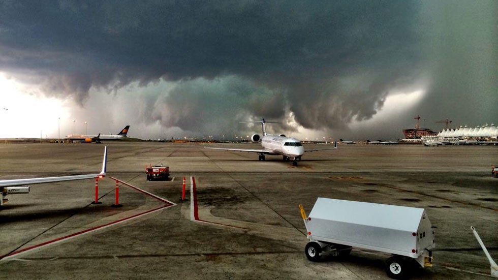 A massive storm cloud forms over Denver International Airport on Wednesday afternoon, May 21, 2014, during a round of severe weather. (Facebook/Devon Alper)