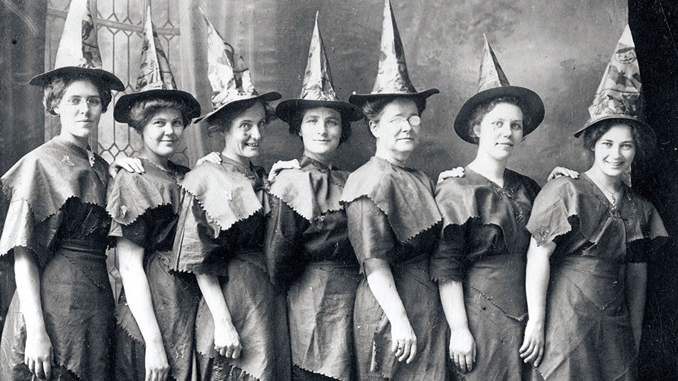 A 'coven of witches' line up for a Halloween portrait dressed in festive witch's hats and improvised costumes circa 1910. (Tanscendental Graphics/Getty Images)