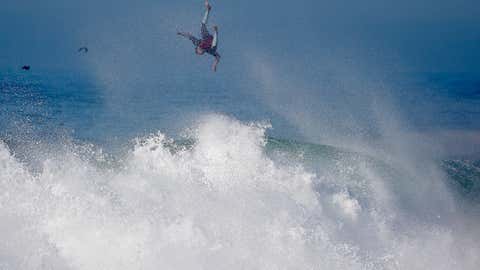 A surfer flies off a wave at the wedge in Newport Beach, Calif., Wednesday, Aug. 27, 2014.(AP Photo/Chris Carlson)