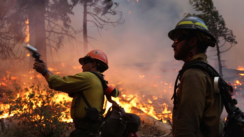 In this photo provided by the U.S. Forest Service, fire crew members stand watch near a controlled burn operation near Yosemite National Park in Calif., Sept. 2, 2013. (AP Photo/U.S. Forest Service/Mike McMillan)