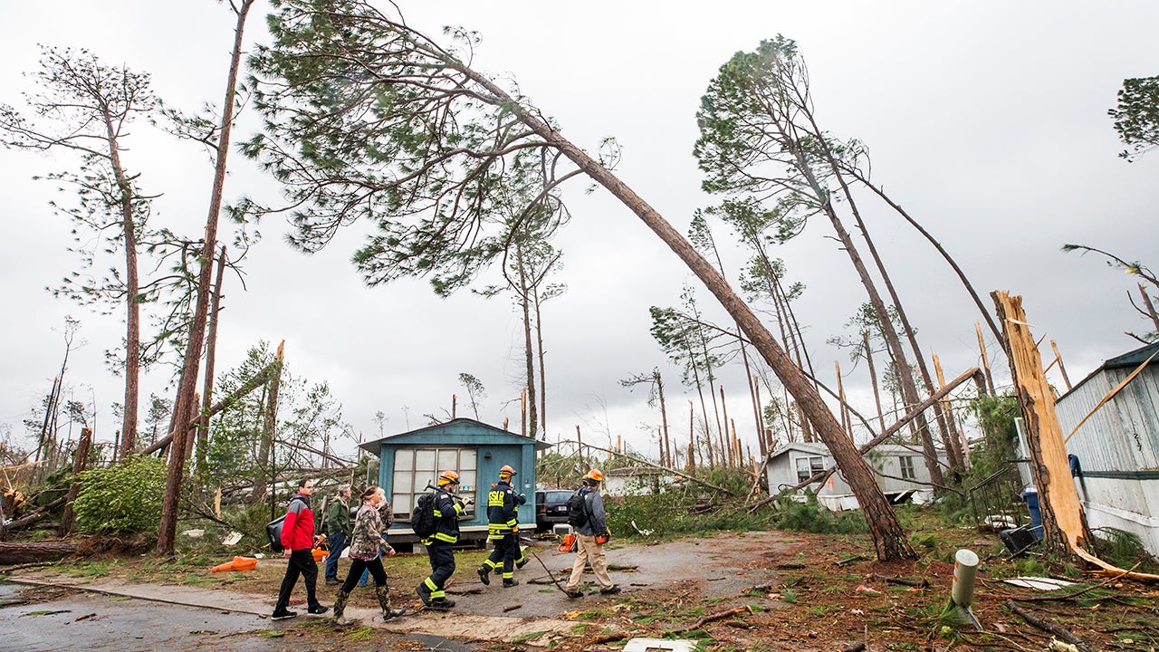 Georgia Search and Rescue team members enter the Big Pine Estates in Albany, Ga. Monday, Jan. 23, 2017, to look for survivors who may still be trapped as well as victims of the tornadoes that hit the Albany area the day before. (Colin Hackley / weather.com)